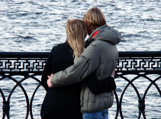 Couple enjoying a walk by the water